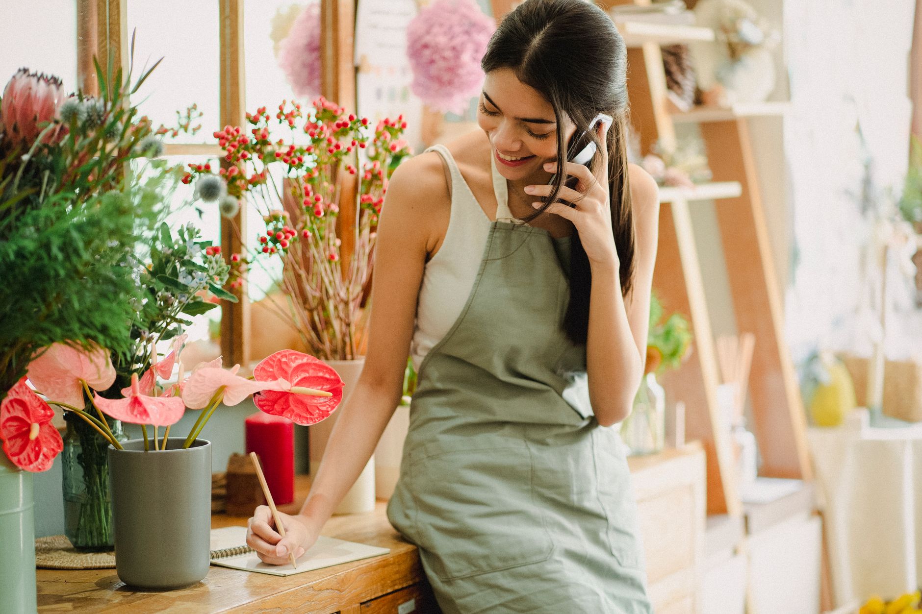 Local business owner taking a customer call after a Google Business Profile post brought in the lead