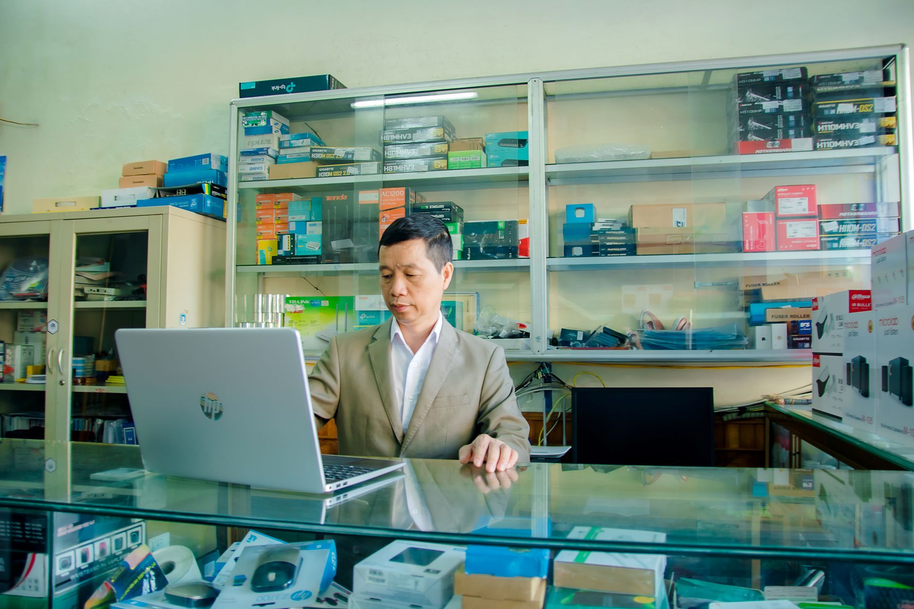 Business owner at a laptop answering Google Business Profile questions during a weekly check