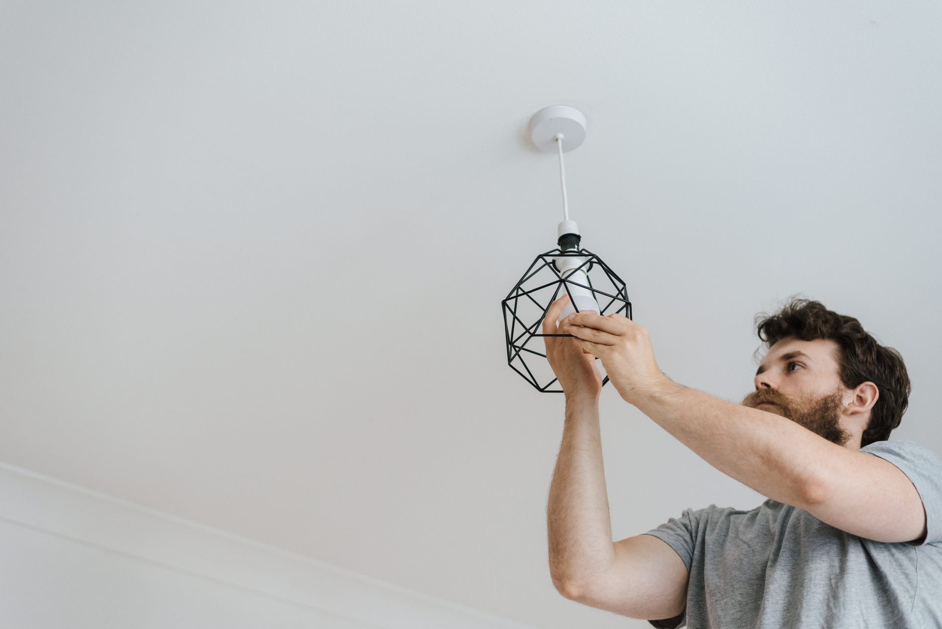 Electrician working on panel representing verified local service contractor