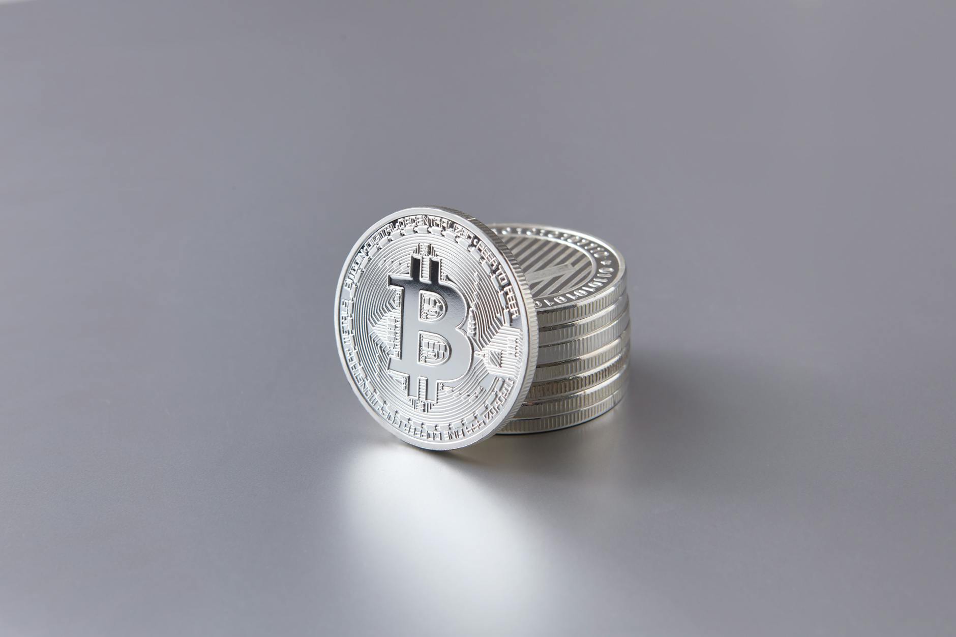Stack of silver coins photographed from above, showing the varied surfaces of bullion coins