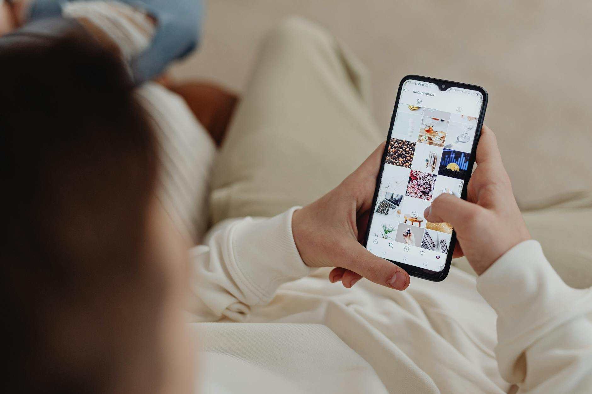 Person using smartphone to browse Instagram Stories on a mobile device