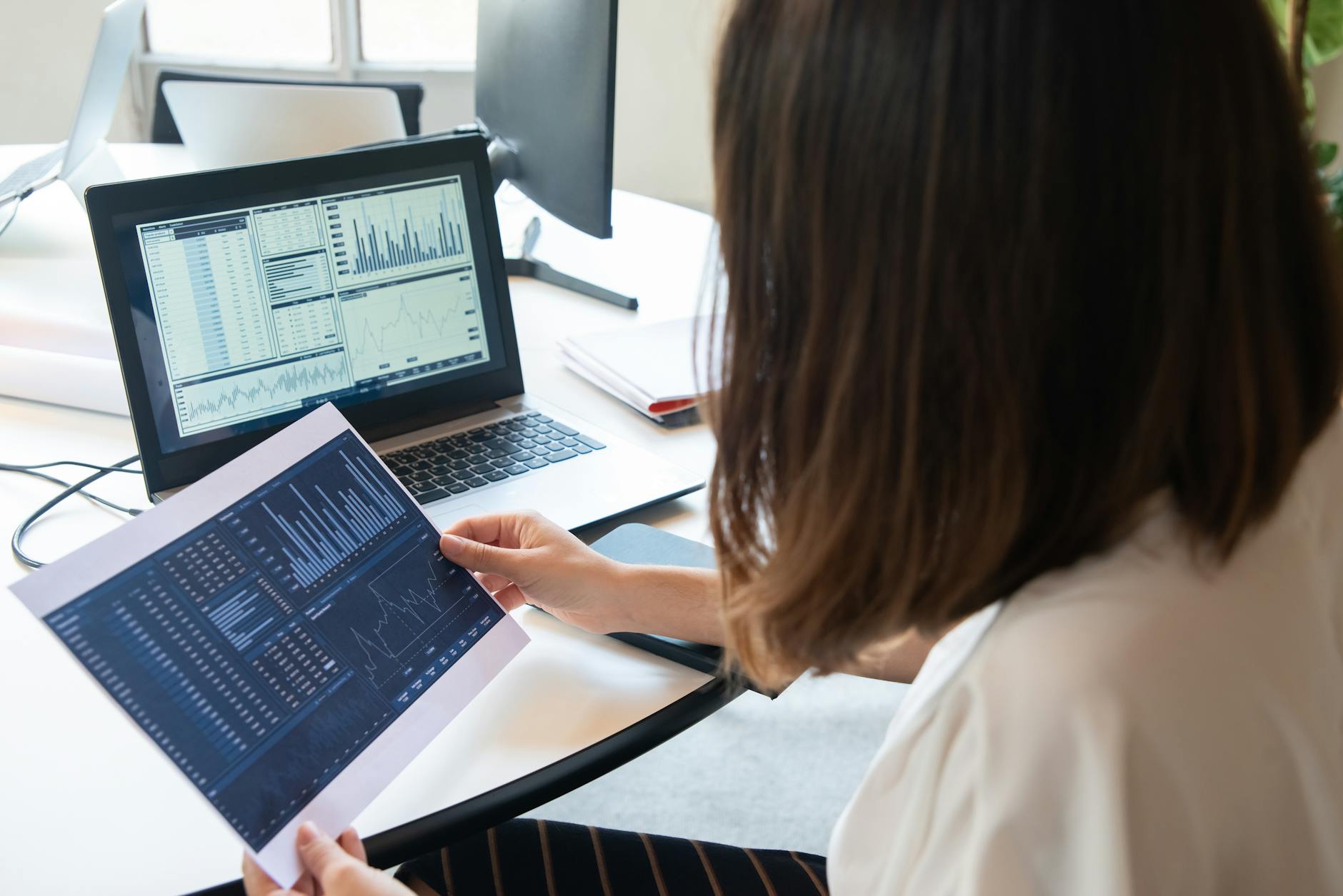 Local business owner reviewing website analytics on laptop at desk