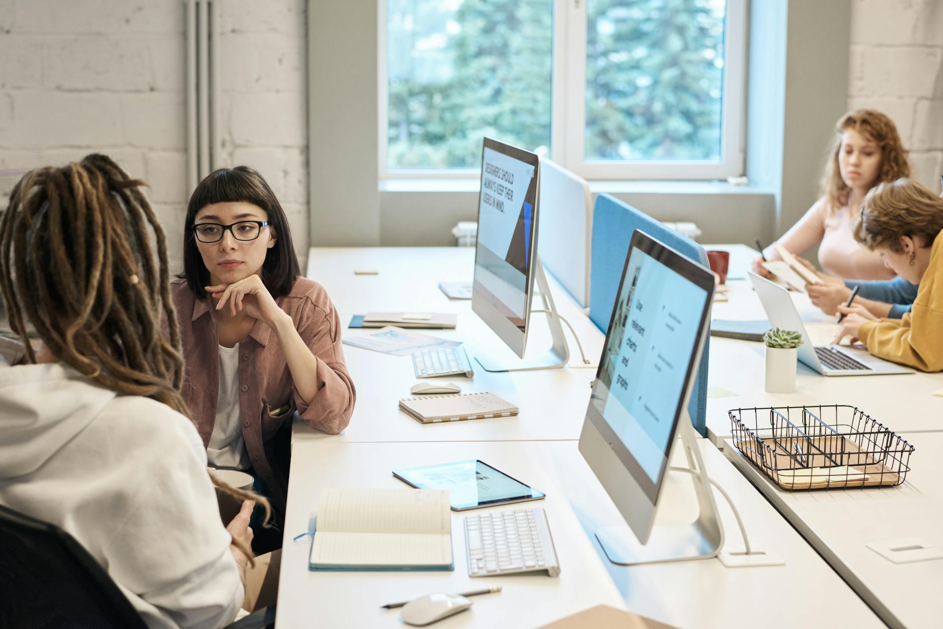 Small business owner looking at website performance data on desktop monitor
