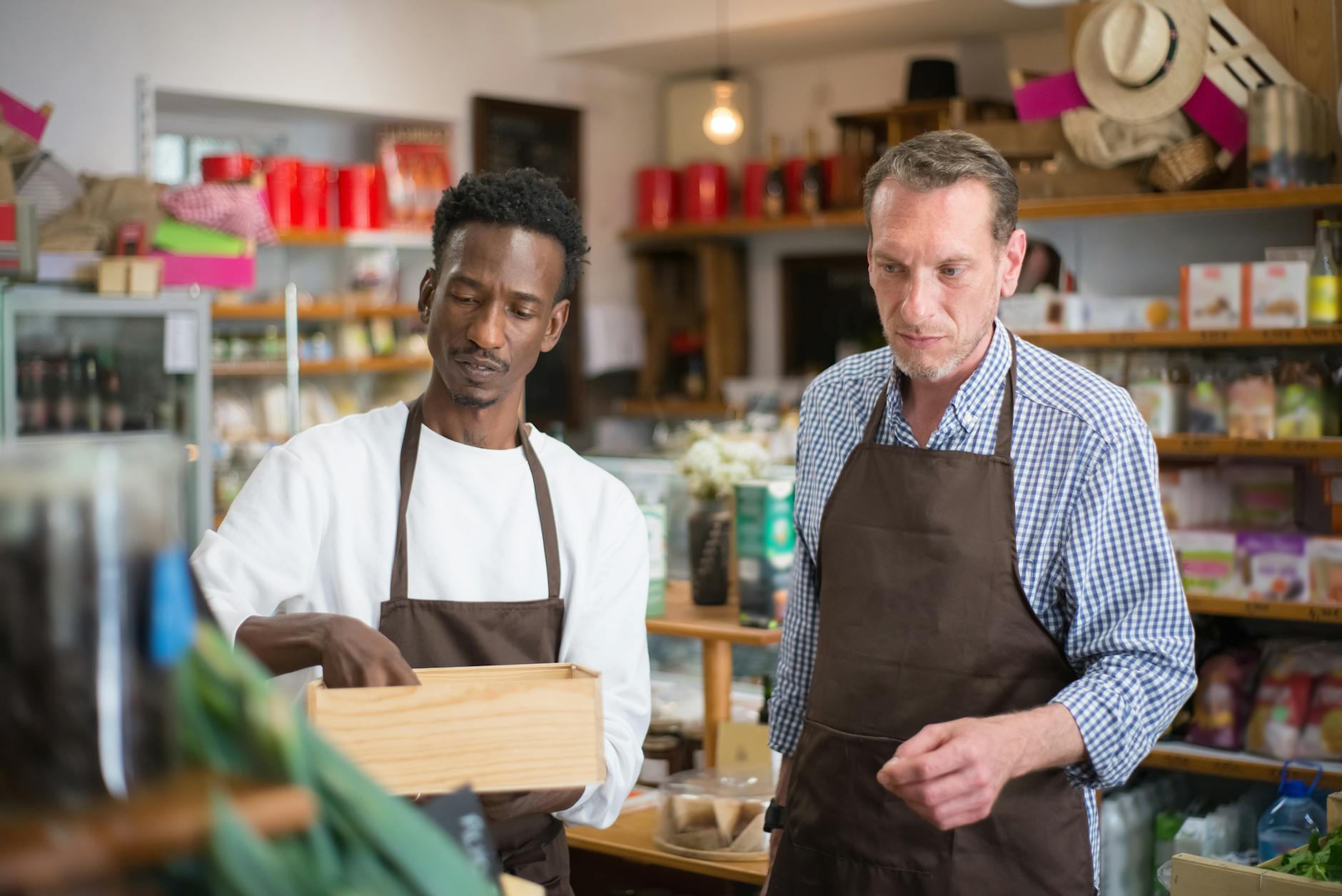 Small business owner talking with a customer in their shop