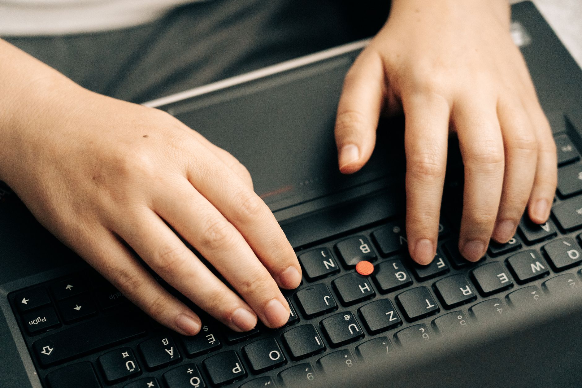Person typing a professional response on a laptop at a desk