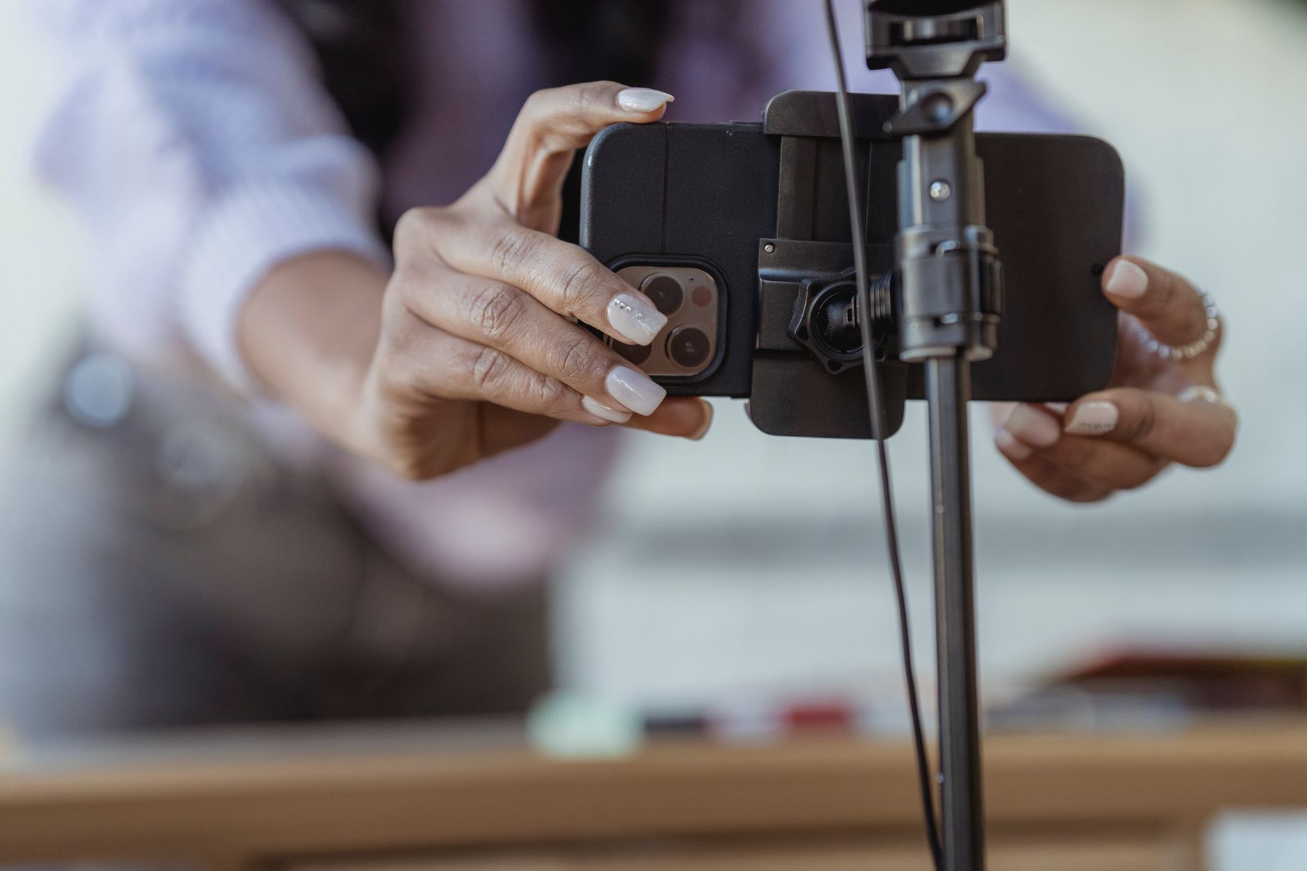 Local business owner filming a short-form video with smartphone for TikTok or Instagram Reels
