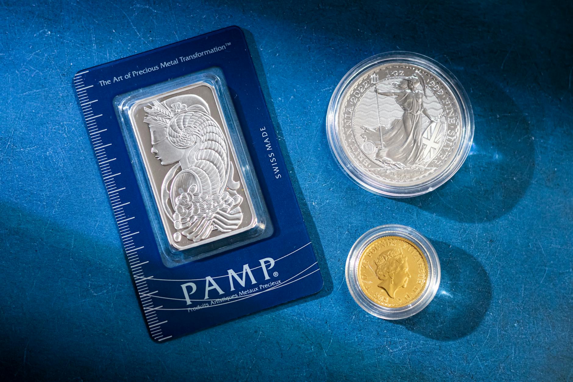 Stacked silver bars on a dark surface