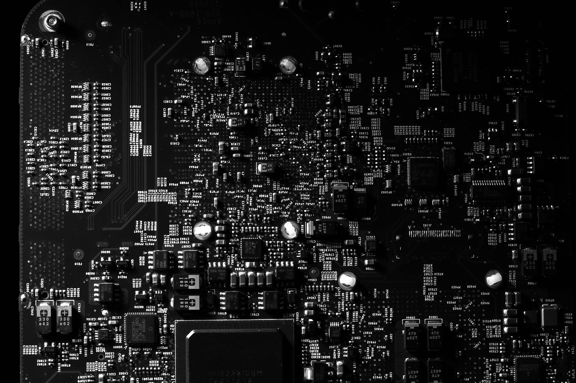 Close-up of a circuit board showing silver solder contacts and conductive traces in electronics manufacturing