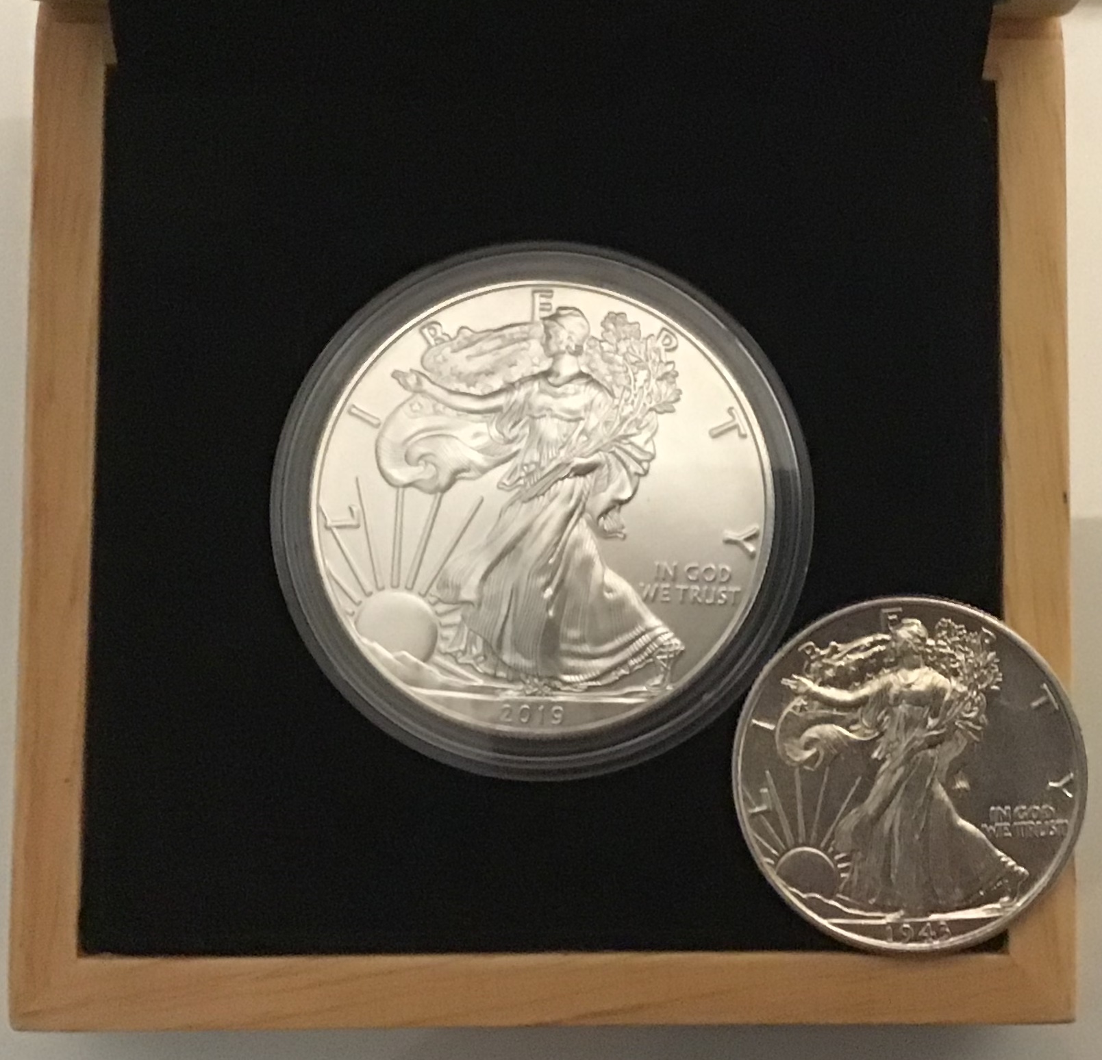 2019 American Silver Eagle and 1943 Walking Liberty Half Dollar side by side, showing two common silver coins worth protecting