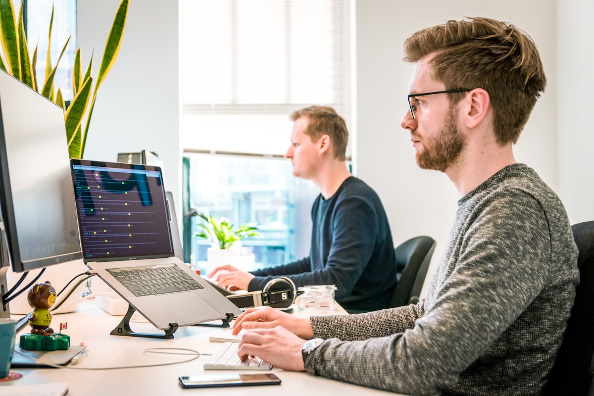 Person working at a laptop in a tidy office environment