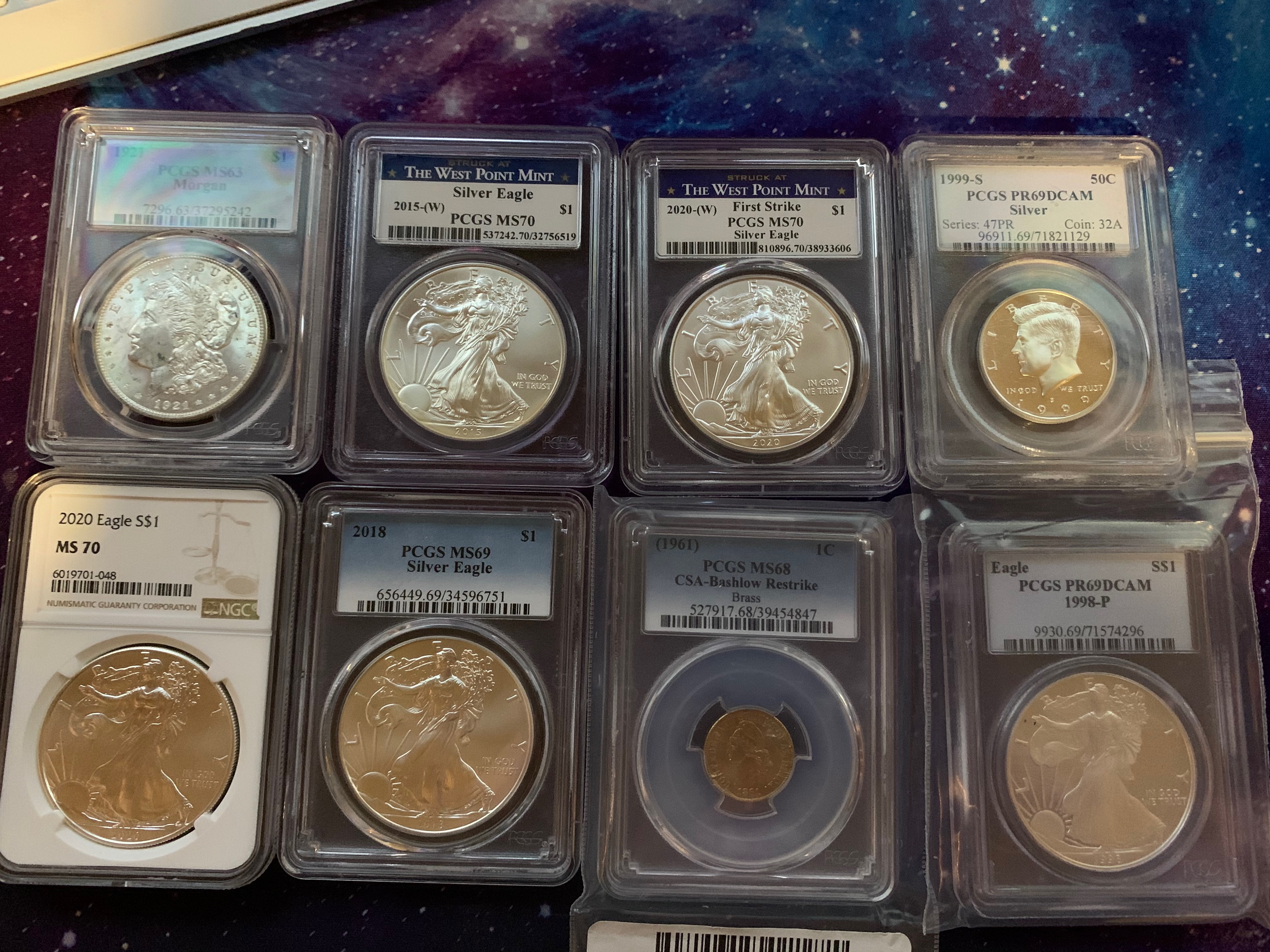 PCGS graded coin slabs including Silver Eagles MS70 and a Kennedy half PR69 DCAM